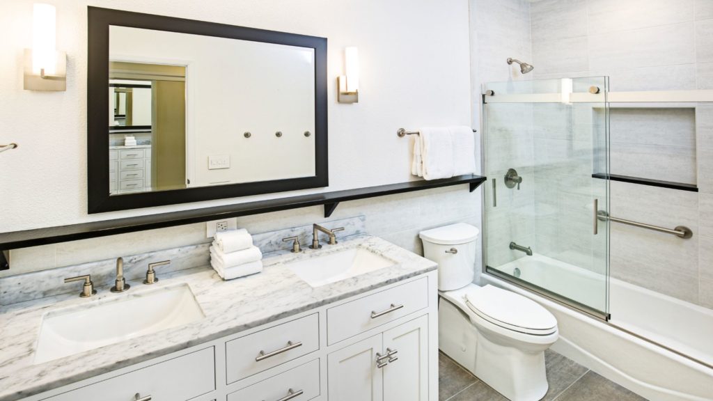 Bathroom with vanity, toilet, and tub