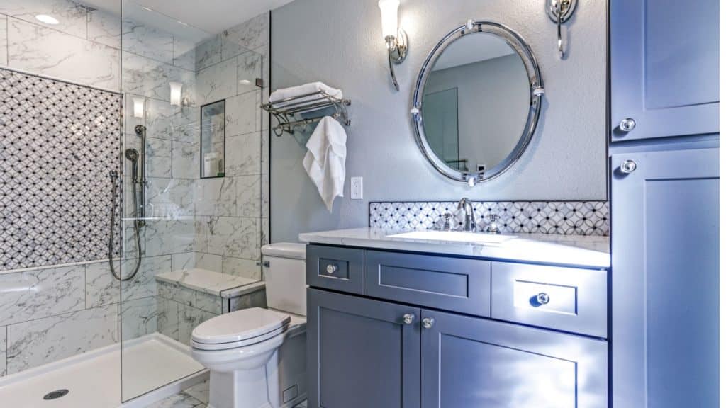 Small bathroom with blue vanity, toilet and shower