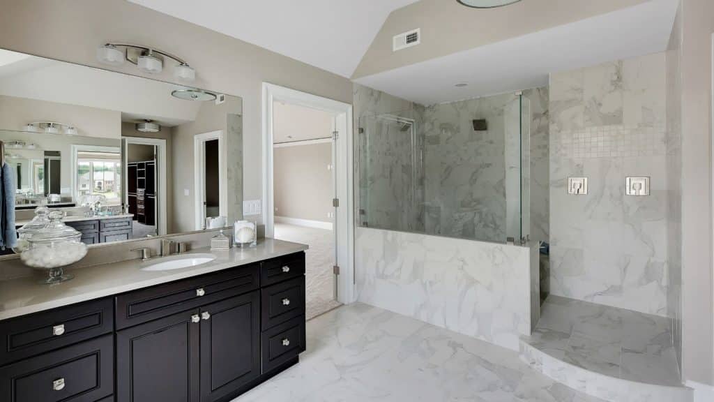 Elegant bathroom with brown vanity, and shower