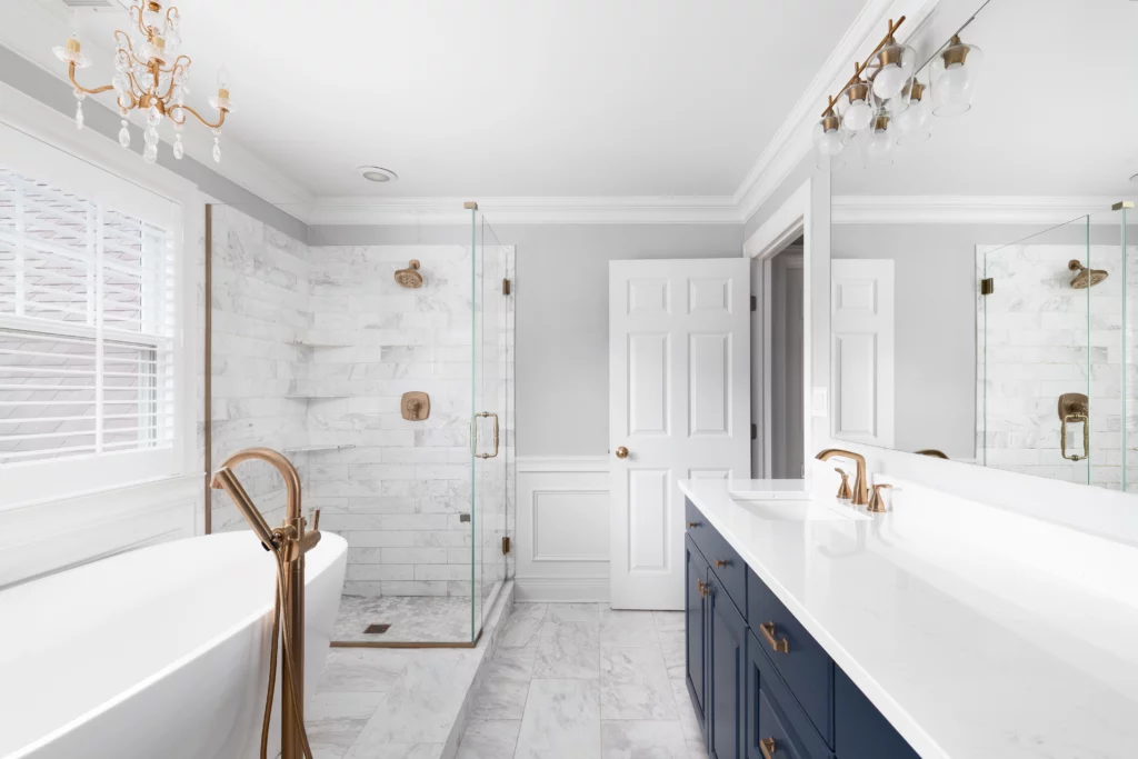 Modern White Bathroom with navy blue bathroom cabinet and white countertop