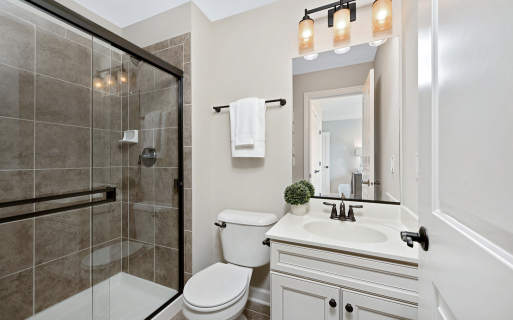 Small bathroom design with vanity, toilet, and shower