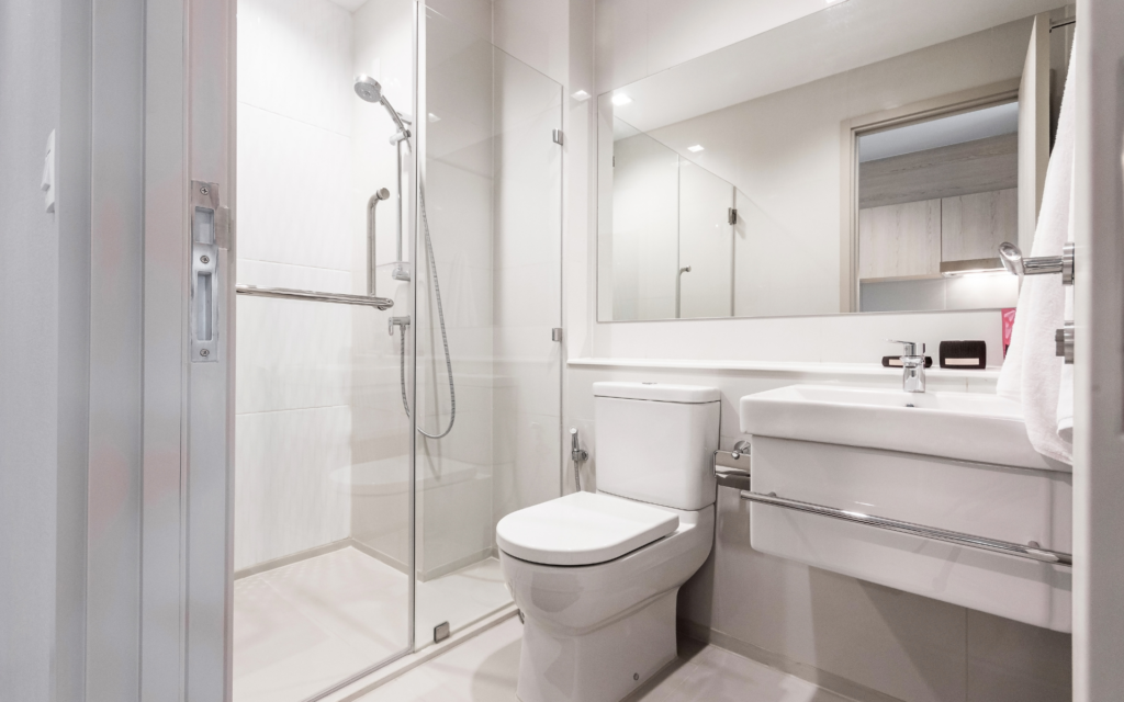 Small white bathroom with floating vanity, toilet, and shower