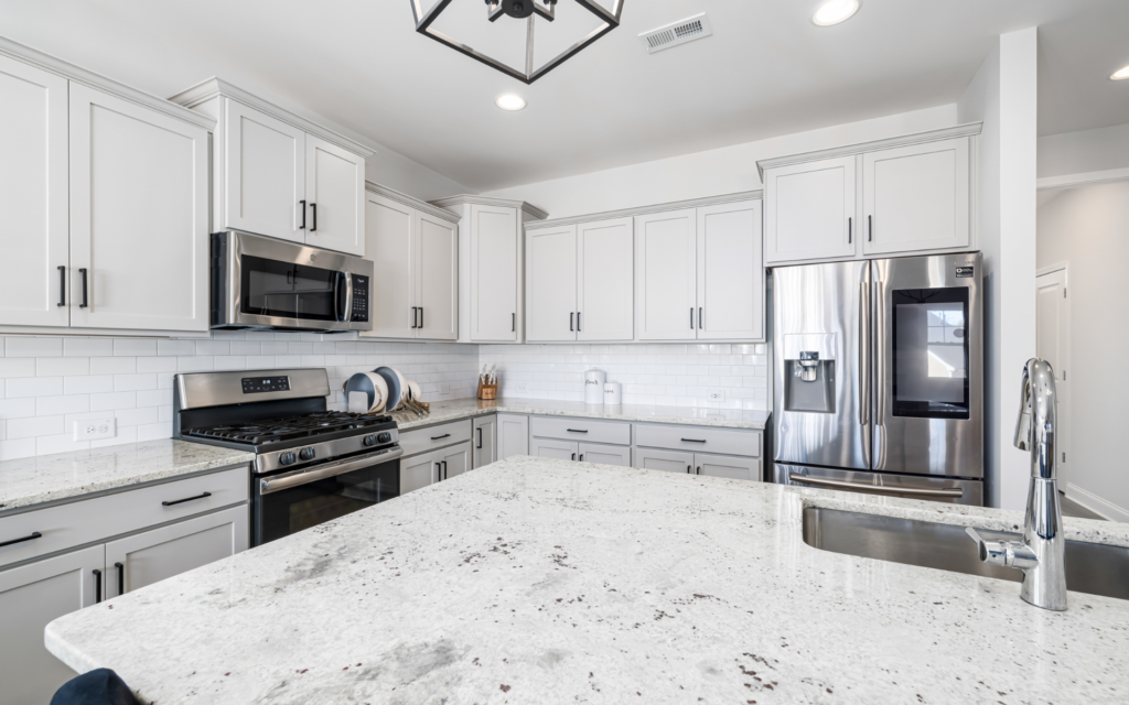 Kitchen with white cabinets and tops